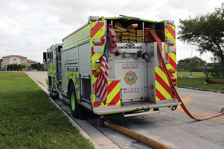 23 A manifold is positioned too close to the apparatus, and there is slack and a bend in the hose. The manifold ends up under the apparatus when the supply line is charged.