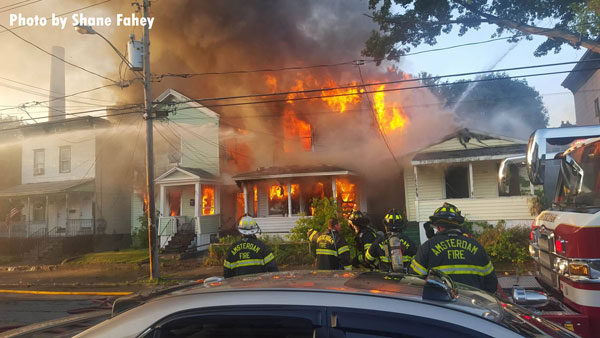 Firefighters confront a raging dwelling fire in Amsterdam, New York.