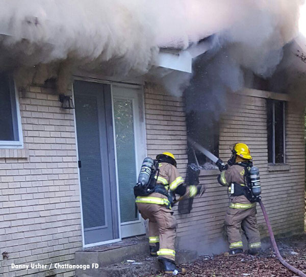 Captain Danny Usher took this photo of Senior Firefighter Julius Hubbard and Firefighter Brandon Polk, both with Engine 15, as they began their attack on the duplex fire on Kemp Drive.