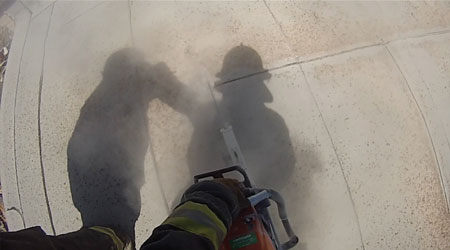 (2) White gypsum dust from saw operations is clearly visible. The member operating a saw under fire conditions should alert the incident commander and evacuate the roof. The member should also leave the roof away from the cut so as not to step on any unsupported areas.