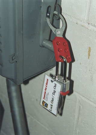 (3) The firefighter is killing the power safely. (4) Lockout/tagout tags indicate the power has been shut off.