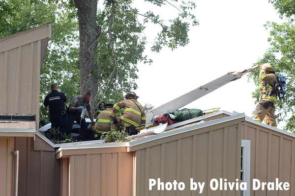 Firefighters respond to a plane crash into a residence.