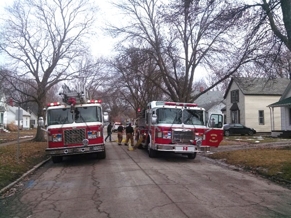 Fire apparatus and firefighters on a residential street.