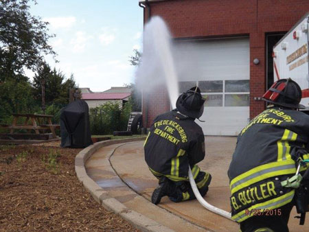 (2) Personnel apply water with a fog nozzle set to a narrow fog for 10 seconds and move the nozzle in a smooth, controlled motion. This is being pumped through a 200-foot, 1½-inch attack line with a 125-gpm, 75-psi fog nozzle.