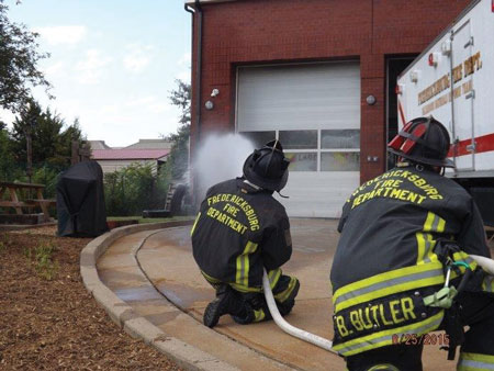 (4) Personnel apply water with a fog nozzle set to a narrow fog for 10 seconds and move the nozzle in a smooth, controlled motion. This is being pumped through a 200-foot, 1½-inch attack line with a 125-gpm, 75-psi fog nozzle.