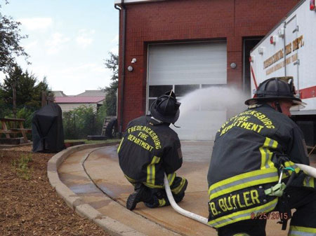 (5) Personnel apply water with a fog nozzle set to a narrow fog for 10 seconds and move the nozzle in a smooth, controlled motion. This is being pumped through a 200-foot, 1½-inch attack line with a 125-gpm, 75-psi fog nozzle.