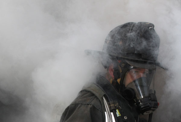 Firefighter in smoke wearing SCBA.