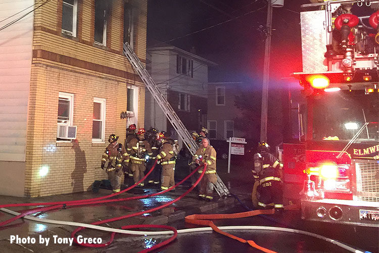 Firefighters outside the scene of a fatal fire in Elmwood Park.