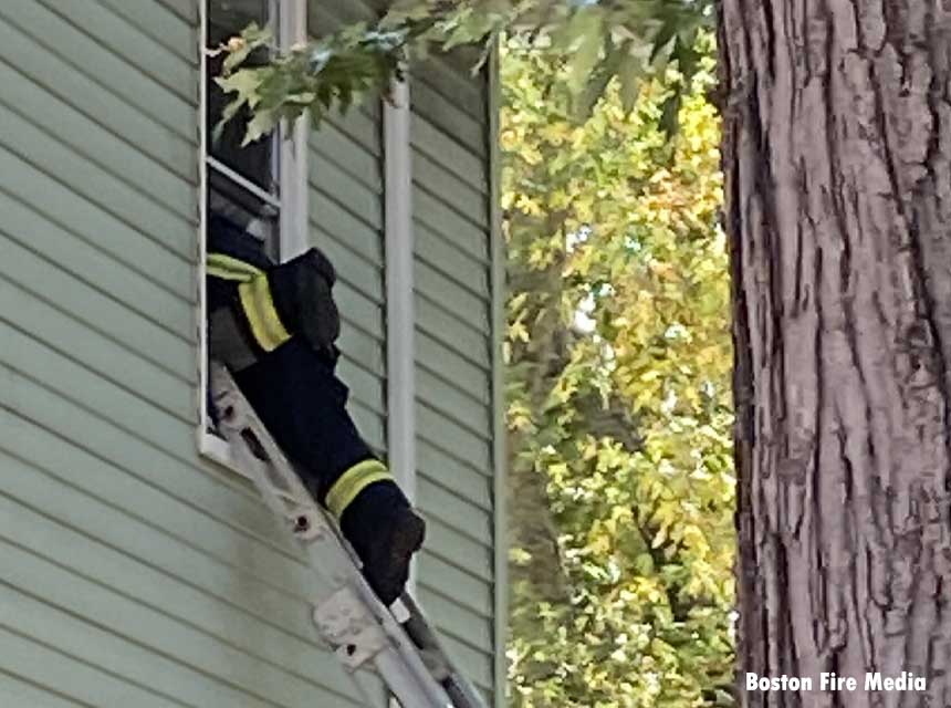 Boston firefighter on a ladder during incident at 103 Hooker St., Brighton