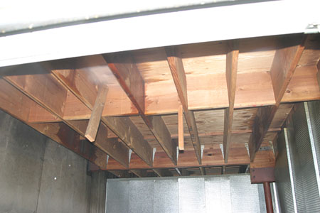 (7) Unprotected wood joists support this second-floor platform in a unit that was not affected by the fire.