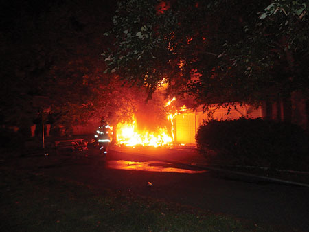 (1) Scenario 1: the initial location of the fire on side B. Note the hoseline is stretched past the exterior fire to side C.<i> [Photos 1-3 courtesy of the Salisbury (MD) Fire Department.]</i> “></td>
</tr>
<tr>
<td align=