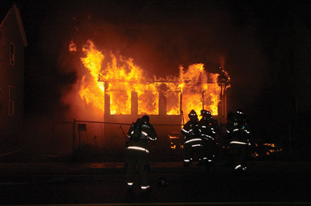 (7) A porch ablaze, a common example of an exterior fire that requires full extinguishment to prevent extension to the interior.