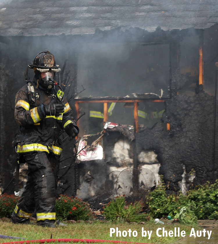 A firefighter ouside the scene of a house fire in Levittown, Pennsylvania.