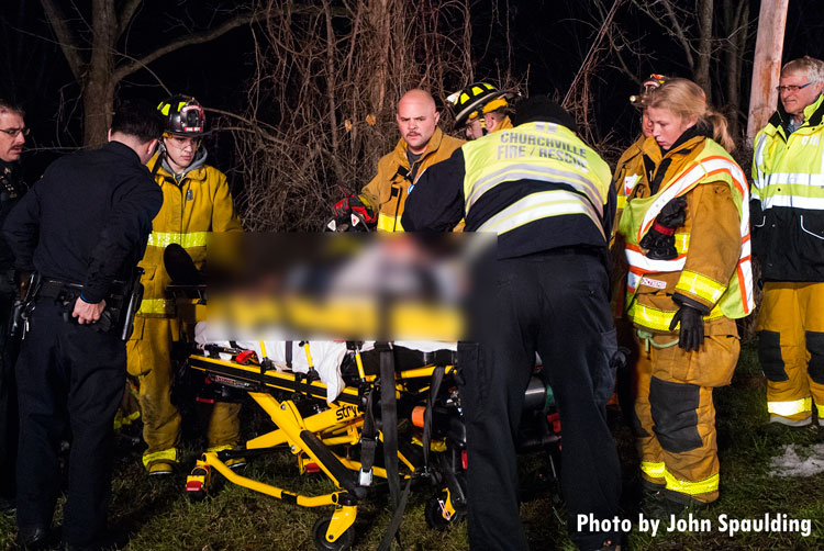 Firefighters remove a patient from a vehicle crash in Churchville, New York.