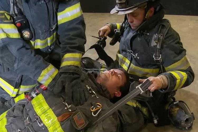 Firefighters perform CPR on a stricken colleague.