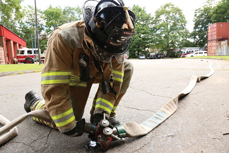 <b>(15) </b>The driver lays down his line, connects it to the gated wye, and opens the gate.<i> (Photo by Matt Van Ness.)</i>