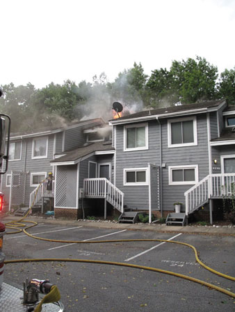 (1) The first-arriving officer transmitted a “working fire” with smoke and fire showing from the roofline. <i>(Photos 1-4 by author.)</i>