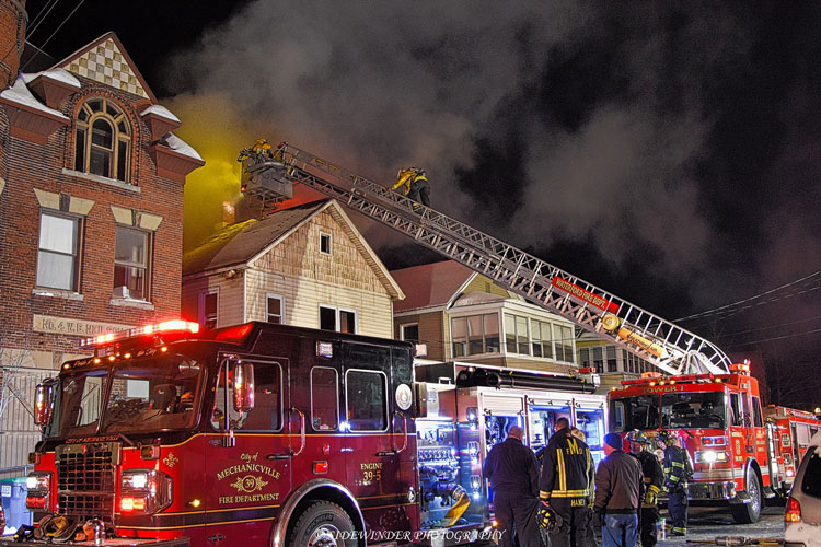 Firefighters and apparatus at the scene of a house fire in Mechanicville, New York.