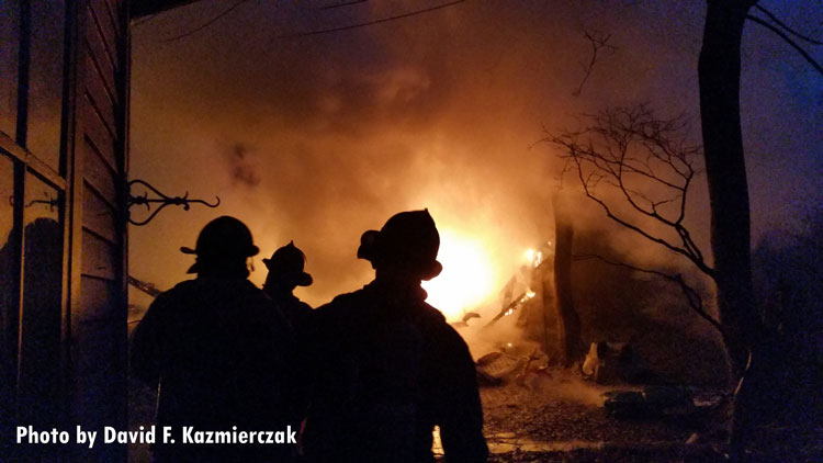 Firefighters at the scene of a garage fire