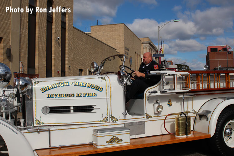 Roy De Young, Jr. driving the department's 1939 Ahrens Fox piston pumper