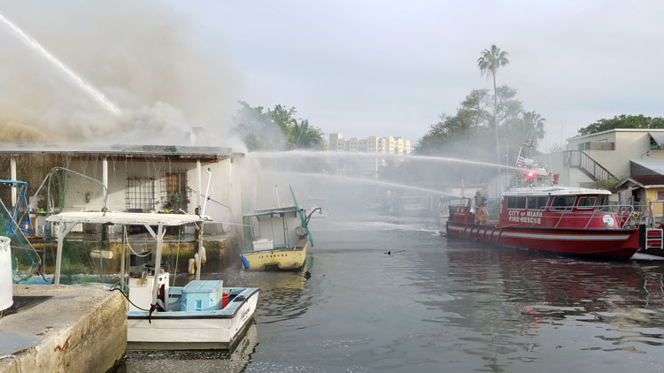 Miami fireboat applies water to fire building