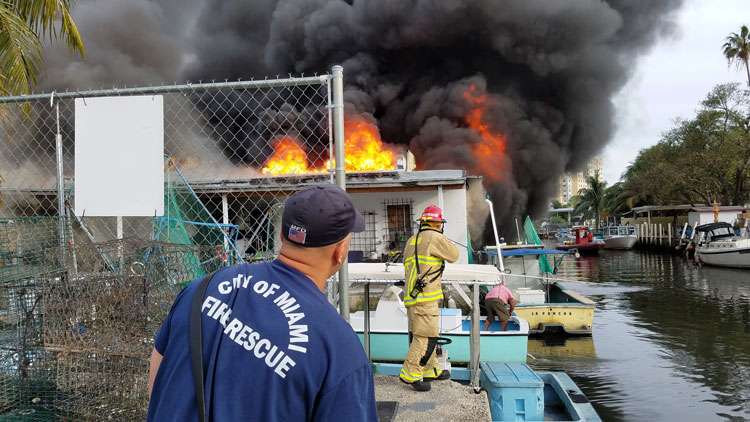 Miami firefighters at the scene of a fire in a boat storage unit.