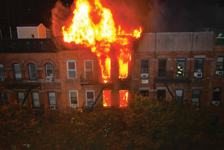 (1) The amount of fire visible on the top two floors and roof indicates the large volume of fire that members had to deal with at this building fire. <i>(Photos 1-7 by Lou Minutoli.) </i>“></td>
</tr>
<tr>
<td align=