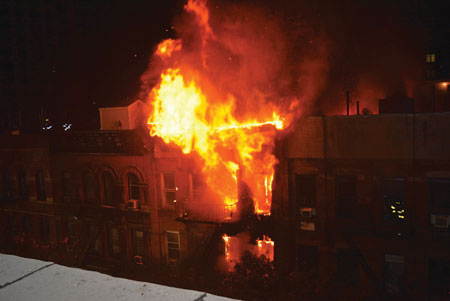 (2) The amount of fire visible in front and the flames visible over the roof in the rear of the building indicate that the apartments were fully involved front to rear.