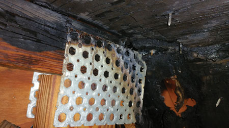 (8) Arcing was sufficient to burn a hole in the mansard’s sheathing, exposing the underside of the clay barrel tile. 