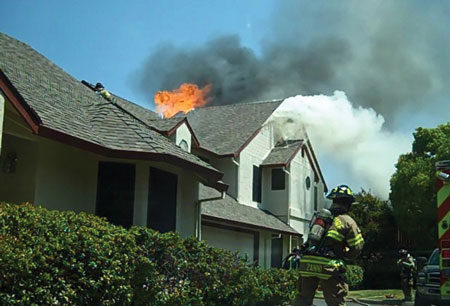 (2) The initial arrival view of a townhouse fire from the command post.