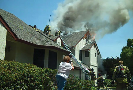 (8) The second battalion chief, seen on the right (holding his helmet), arrives and replaces the company officer, who was Division A. This allows the company officer to return to his crew. The second battalion chief could assume another division role or be the RIC group supervisor if the fire warranted it. The captain on the roof is the roof division supervisor.