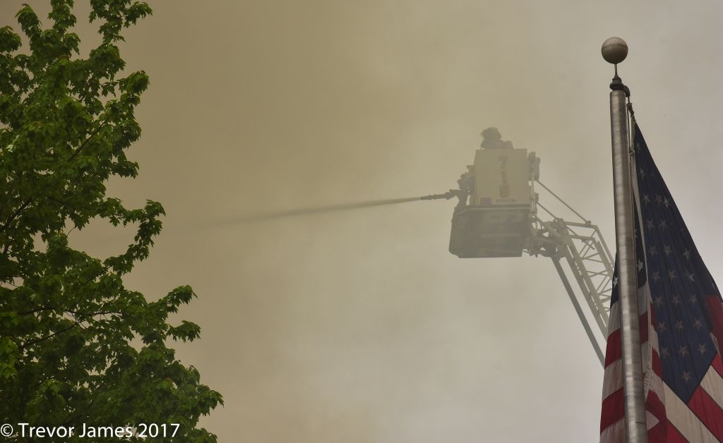 Firefighter in a bucket with hose stream