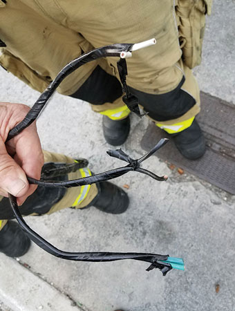 <b>(5-6)</b> Three extension cords wrapped in electrical tape were run up this utility pole. “></td>
</tr>
<tr>
<td align=