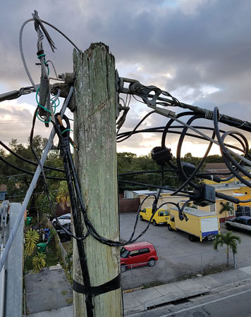  (7) This illegal electric service is connected to utility company wires.