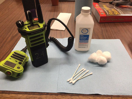 (1) A quick setup for portable radio cleaning includes isopropyl alcohol, cotton balls, cotton swabs, and a few paper towels. <i>(Photos by author.)</i>