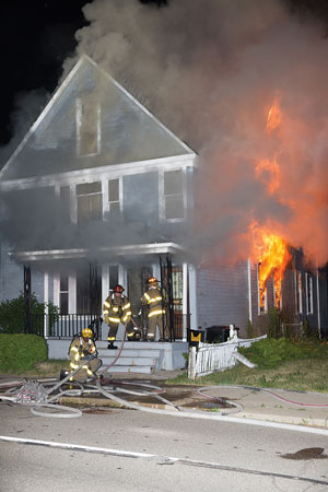 (<b>1-3)</b> First-arriving firefighters find a heavy fire condition on the first floor of what appears to be a 2½-story wood-frame dwelling with fire extending to the second floor and attic half-story. <i>(Photos by Gordon Nord.)</i>