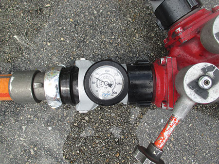 (6) The pressure to the 1¾-inch hoseline, as read on an inline gauge, is controlled at the wye by partially opening the wye’s outlet. The proper pressure is maintained by setting the pump discharge pressure to supply two lines and locking the wye valve handles in position. <i>(Photo by Eric Goodman.)</i>