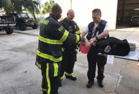 (4) Battalion Chief James Quinn and his crews demonstrating the hood exchange program and “hazardous overpacking” of contaminated hoods before being sent for advanced cleaning. (Photo by Todd Leduc.)