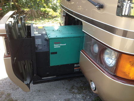 (2) The generator is stored where you expect the motor to be, to keep the noise down in the sleeping areas. (3) The controls for the tanks containing drinking water and nonpotable wastewater. (4) This 75-pound LP cylinder supplies all gas appliances and usually has a quick connect or separate 20-pound cylinder for an outside barbecue (arrow).