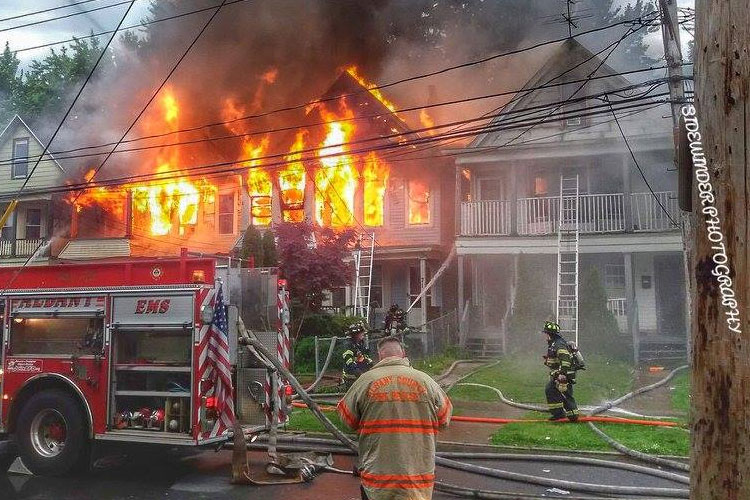 Firefighters at the scene of a fire extending through multiple homes in Albany, New York