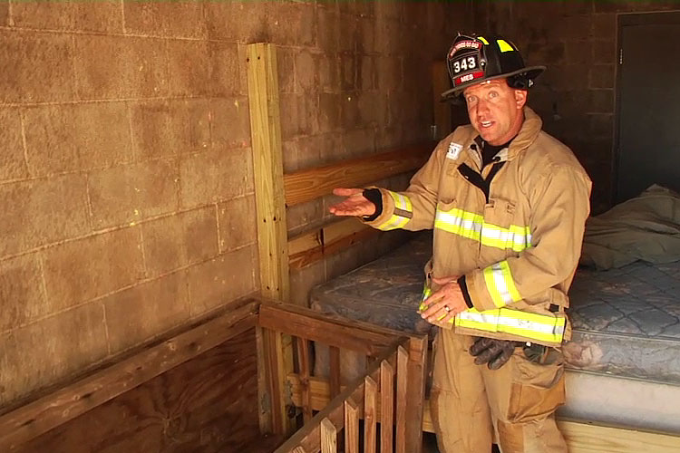 Firefighter with a baby's crib