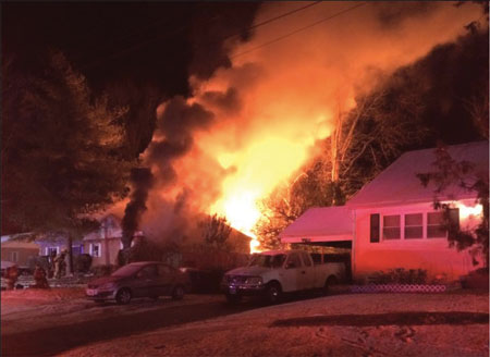 (4) Look for survivable spaces in well-involved structures. On this response, heavy fire was issuing out of side C on arrival. Note the front window with black smoke issuing out; crews were performing a successful vent-enter-search operation in this room. Also, look for and search the bedrooms.