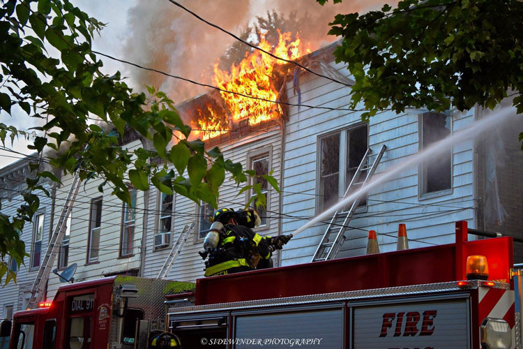 Firefighters use a deck gun at a structure fire