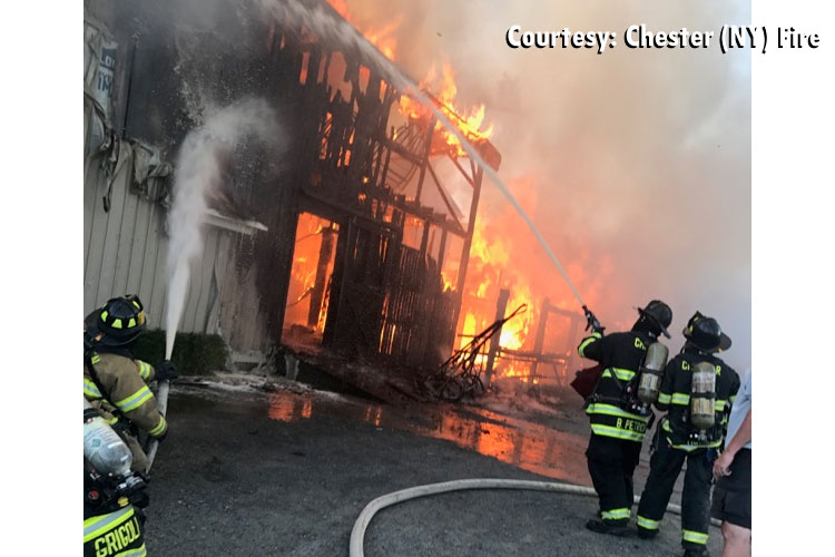 Firefighters apply water to a structure fire in Goshen