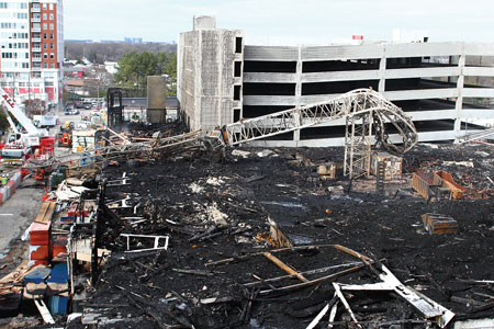 (4) The twisted remains of a construction crane were visible the morning after; the crane had collapsed across Harrington Street and onto an industrial building.