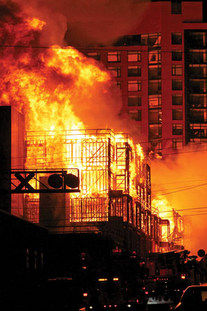 (1) A view from the northwest corner shows the massive flames and the Quorum high-rise in the background. <i>(Photos by Mike Legeros.)</i> 