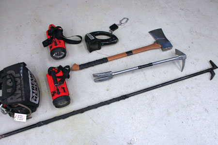 (1) The basic tools of search: flathead ax, halligan bar, two flashlights, looped webbing, rope bag for larger residences, and a New York Hook. Use the hook only to help extend into a room to reach and close and control doors. Do not drag pike poles and New York hooks around in residential searches. (Photos by author.)