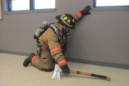 (4) The position of the flathead ax when searching low. Sweep the floor ahead and to the side as you go, keeping the handle forward while the blade is positioned toward the floor. 