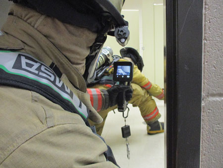 (8) Ideally, have the control member at the door with a thermal imaging camera (TIC) if possible as the other member searches. This may not always be possible because of limited time, or a TIC may be unavailable. Remember voice communication is imperative to stay oriented and safe.