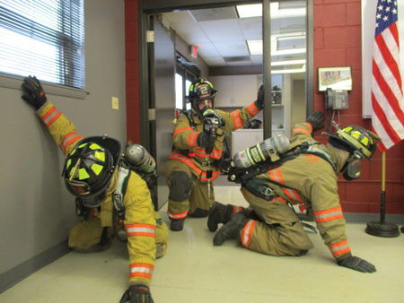 (9) Ideally, if three rescuers are available for larger areas, position a control member at the door with the TIC as the other two rescuers navigate the larger area. The control man with the TIC and voice communication can keep the search oriented and enable the searchers to safely return to the door.